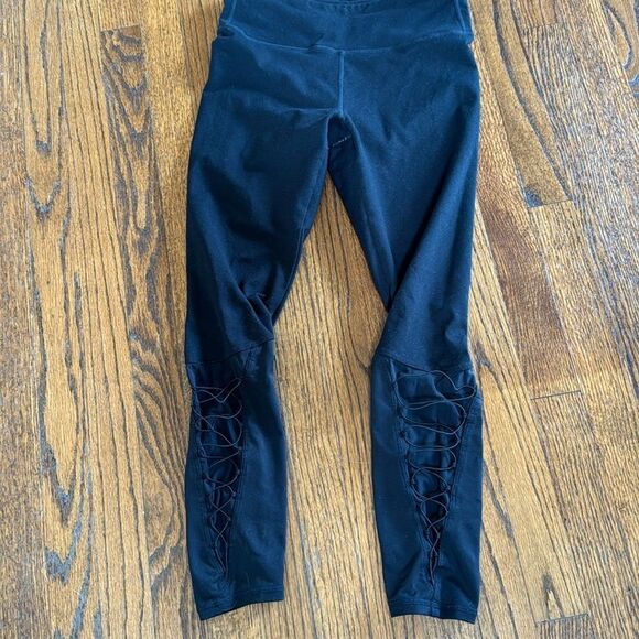 Fabletics black leggings. Lower outer legs w/ mesh coded lace up detail. Medium - Picture 1 of 4
